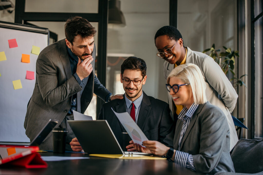 Team of business professionals collaborating in a modern office environment.